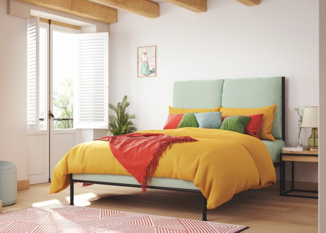 Calliope Upholstered Iron Bed Frame. Green upholstery, yellow throw and coloured cushions