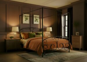 lyra iron bed. Four poster in a cosy room.